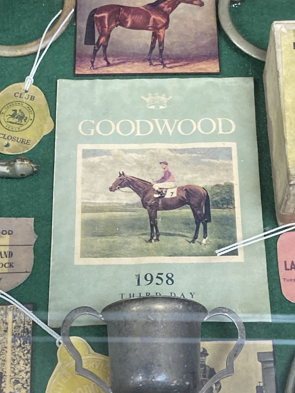 Horse racing memorabilia, arranged and contained in a glazed case, over height 56cm width 46cm